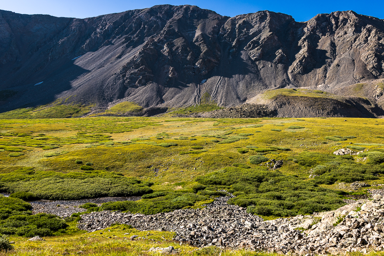 Mountain shadows behind smaller front range peaks