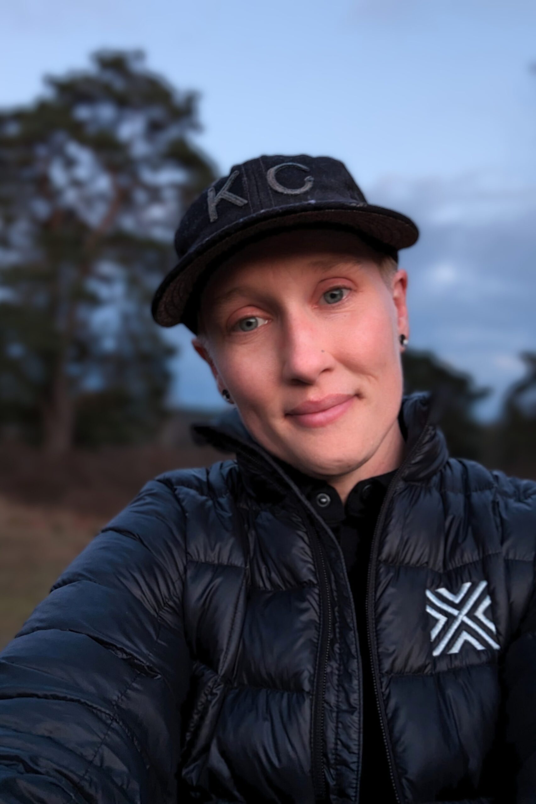 Heather Physioc, photographer and writer from KCTRVLR, just after sunset in early spring, among the pinus sylvestris trees and heathlands on the dunes in the Veluwe landscape of the Netherlands, just outside Otterlo